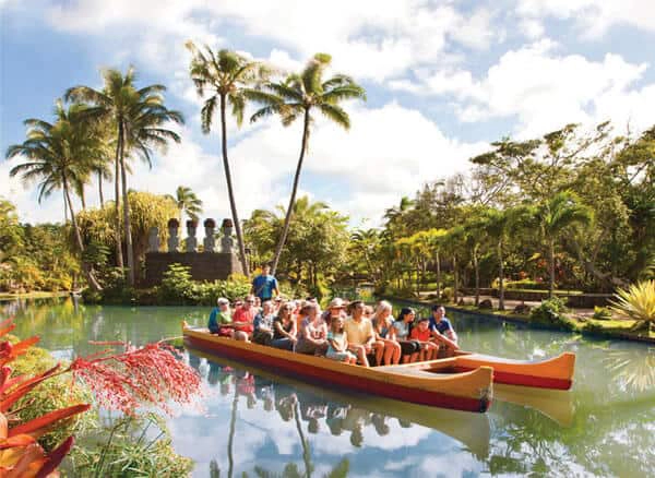 Guests riding in a canoe through a tropical lagoon